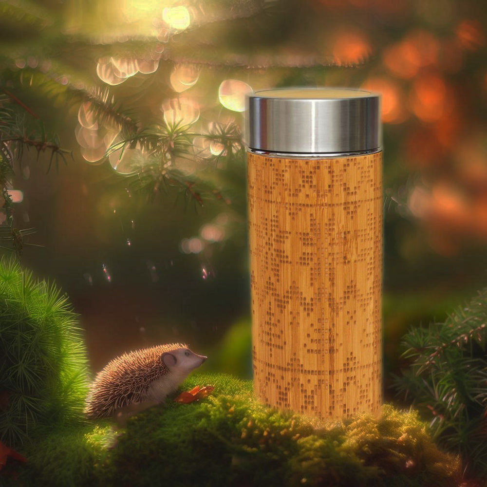bamboo thermos with ethnic nordic engraving in forest with the hedgehog in the moss